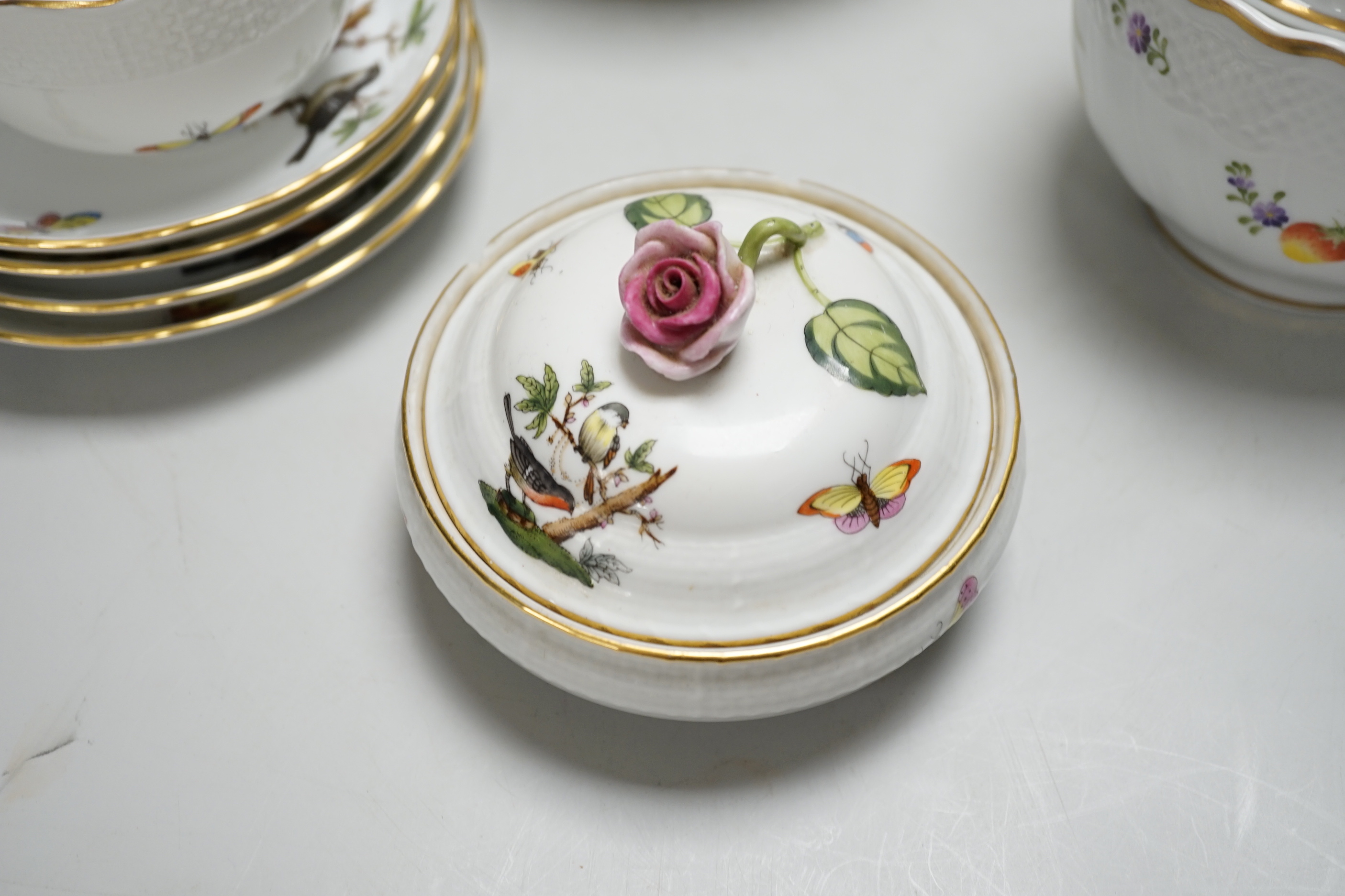 A Herend handpainted pot and cover, a cup and four saucers and teapot decorated with birds and insects and a similar sucrier and cover decorated with fruit